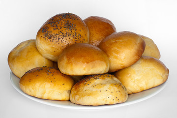 fresh breakfast rolls on a plate with white background