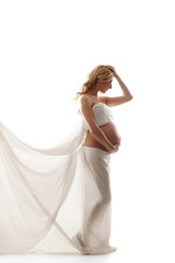 Fototapeta premium A young and happy blond pregnant Caucasian woman