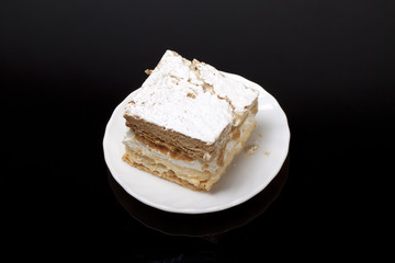 sweet  cake with cream isolated on black