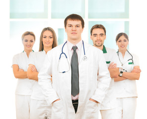 A team of young and smart Caucasian doctors in white