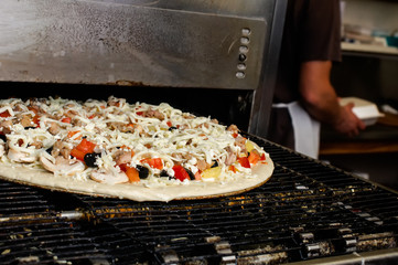 Baking pizza in commercial oven.