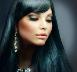 Beautiful Brunette Girl. Healthy Long Hair and Holiday Makeup