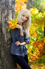 Young beautiful woman in autumn park