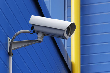 surveillance camera next to yellow pipe