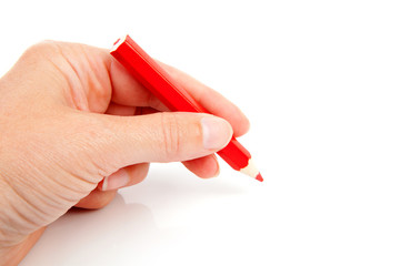 hand is holding red pencil and writes