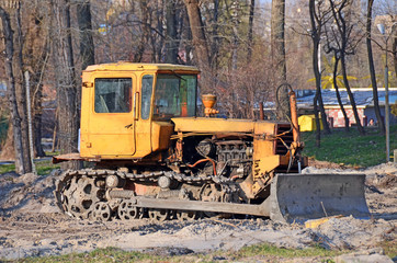 Tractor on old park road construction site