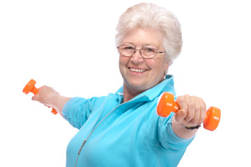 Senior woman working with weights in gym