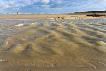 Seaside with water stream