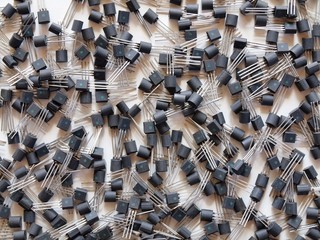 Background with components of electronics - black transistors