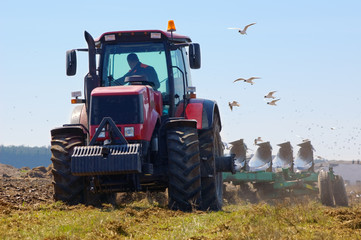 Farmer plowing the new field in spring