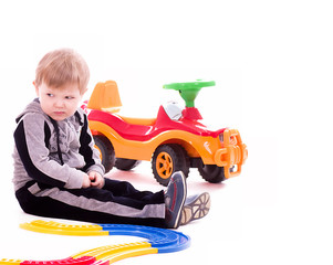 Baby boy with a big car on white background