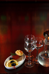 three glasses of vodka and a bottle