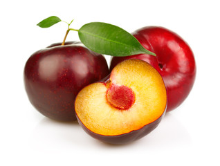 Fototapeta na wymiar Ripe plums fruit with slices isolated on white