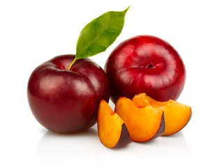 Ripe plums fruit with slices isolated on white