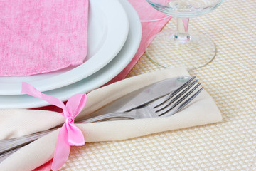 Table setting with fork, knife, plates, and napkin