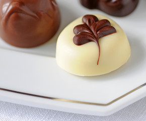 Belgian chocolates on silver lined plate, shallow dof