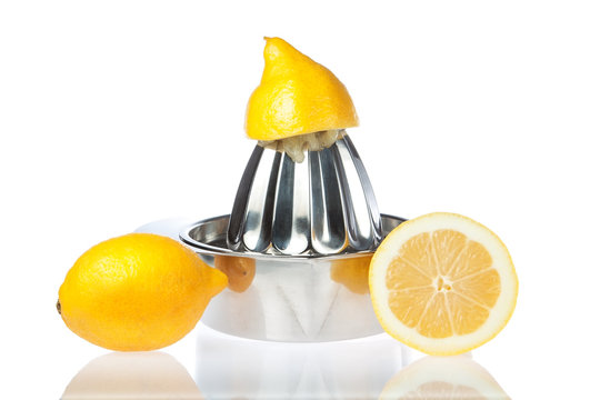 Juicer with fresh lemons. On a white background.