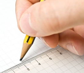 Writing. An hand who writes in a paper sheet with a pencil