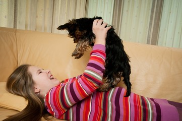 Portrait of child playing with dog