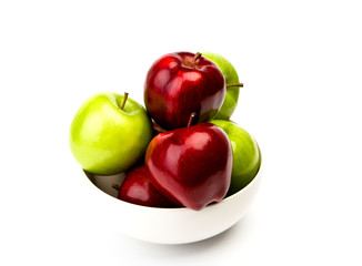 Green and red apple on plate isolated on white background