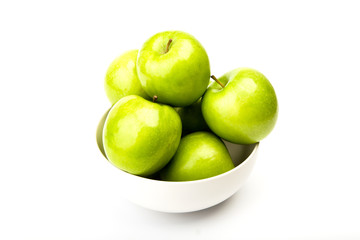 Green apple on plate isolated on white background