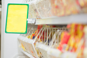 Shelves with food and info label in supermarket