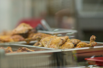 Fried grill chicken wings and legs on table in supermarket