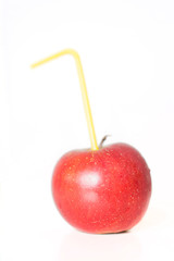 Red juicy apple with straw on white