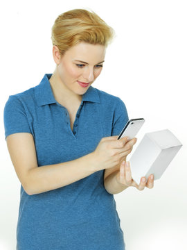 Pretty woman scans a scancode with her cellphone