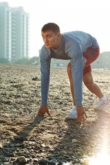 young man warming-up at early morning