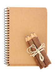 Notebook and pencils on white