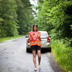 Young female driver after her car has broken down