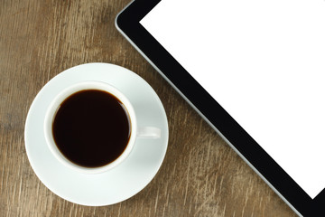 Fototapeta na wymiar Urządzeniu z ekranem dotykowym i filiżankę kawy na starym drewnianym tle