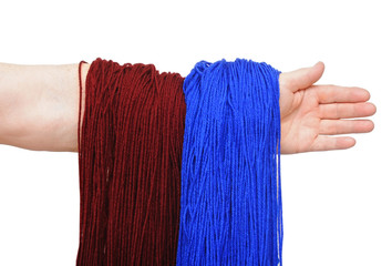 Woman hand with blue and brown ball of yarn for knitting isolate