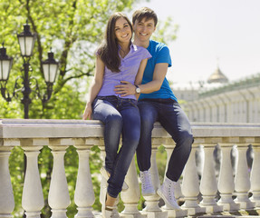 young romantic couple sitting in park enjoying themselves - Outd