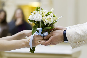 bouquet in the hands of the bride and groom