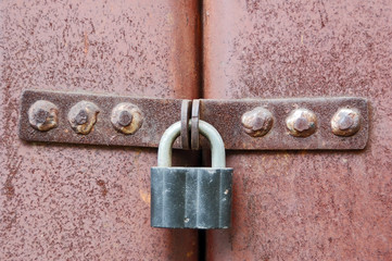 Rusty vintage lock on old garage gate
