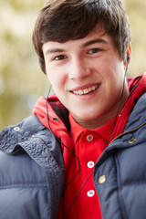 Teenage Boy Wearing Earphones And Listening To Music Wearing Win