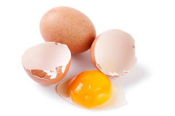 Broken egg and yolk, white background