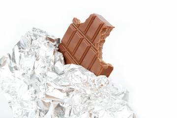Chocolate bar in foil isolated on white background