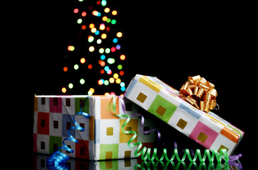 open gift box with bokeh background on black