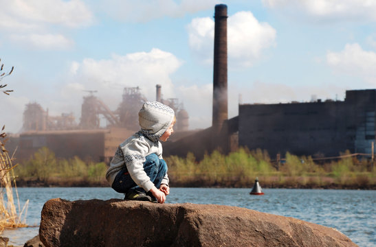 Industrial landscape with playing boy