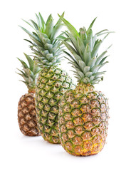 three ripe pineapple on a white background