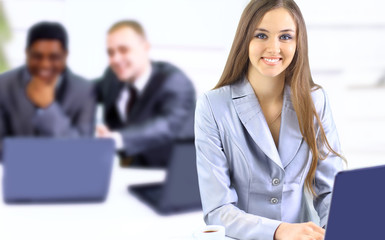 Beautiful businesswoman keeps the laptop.