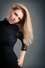 Portrait of beautiful blonde woman with black lace dress