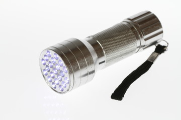 LED flashlight switched on, isolated on white