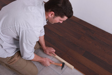 Man laying a hardwood floor