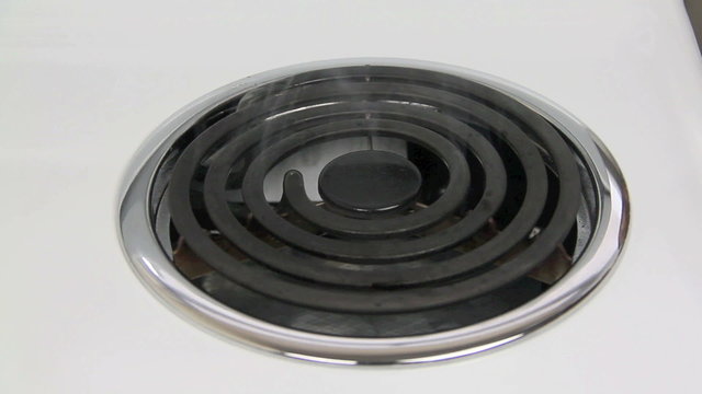 Cooking oil burning off on a stove hot plate.