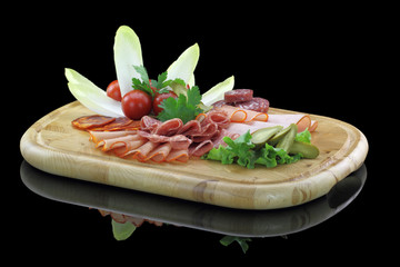 Meat delicatessen plate with vegetables
