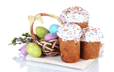 Beautiful Easter cakes, colorful eggs in basket and flowers